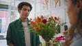 Dreamy african man smell flowers composition. Young man enjoy floral bouquet. Royalty Free Stock Photo