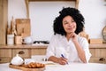 dreamy afro americsn woman write thoughts and ideas in diary