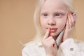 Dreamy albino child talking on phone