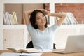 Dreamy Asian student distracted from studying thinking Royalty Free Stock Photo