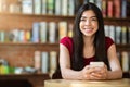 Dreamy Asian Girl Sitting With Smartphone At Table In Coffee Shop