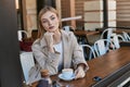 dreamy blonde woman in trench coat