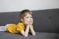 Dreamy boy lies on the sofa Royalty Free Stock Photo