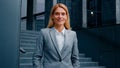 Dreamy business lady standing near office building looking to side confident businesswoman professional manager leader Royalty Free Stock Photo