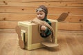 Dreamy child. Brave dreamer boy playing with a cardboard airplane Royalty Free Stock Photo