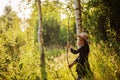 Dreamy child girl on summer walk on riverside. Cozy rural scene. Outdoor activities Royalty Free Stock Photo