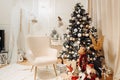 Dreamy christmas decor photo corner with gifts, lights and christmas tree