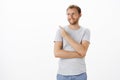 Dreamy and creative ambitious male entrepreneur standing over white background pointing and gazing at upper left corner Royalty Free Stock Photo