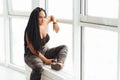 Dreamy creative sensual woman sitting by the window Royalty Free Stock Photo