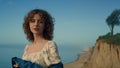 Dreamy girl standing alone on sand beach close up. Portrait of beautiful woman. Royalty Free Stock Photo