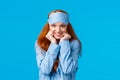 Dreamy and cute, lovely feminine redhead woman in sleep mask and nightwear, leaning closer to hear amusing story during