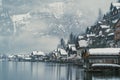 Dreamy European village on a lake covered by fog and romantic and mysterious winter.