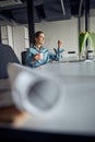 Beautiful office worker daydreaming in the workplace