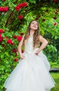 Dreamy girl ballroom dress in rose garden, supernatural fairy concept Royalty Free Stock Photo