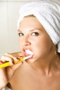 Dreamy girl brushing teeth