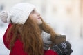 Dreamy girl with cup of coffee looking up in sky Royalty Free Stock Photo