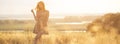 Dreamy girl in a field at sunset, a young woman in a haze from the sun enjoying nature, romantic style Royalty Free Stock Photo