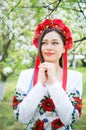 Dreamy girl in national clothes in a flowering garden