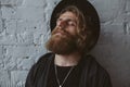 Dreamy guy with beard wearing hat