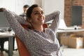 Dreamy happy indian businesswoman relaxing taking break at work Royalty Free Stock Photo