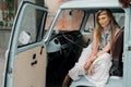 Dreamy hippie woman driving a classic camper van