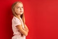 Dreamy little girl in contemlation isolated in studio Royalty Free Stock Photo