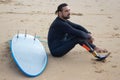 Dreamy mid adult man resting after training on beach Royalty Free Stock Photo