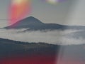 Dreamy misty landscape above the sea of clouds, town in mist