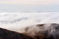 A dreamy mountain scene with clouds cover on a mountain hill. Pa