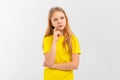 Dreamy nice pretty teen girl touch chin, thought choose decide solve problems dilemmas, wears yellow tshirt. Indoor studio shot on