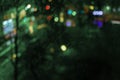 Dreamy night city with multi-colored lights outside a rainy window. Abstract bokeh background for text and design. Toned photo Royalty Free Stock Photo