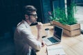 Dreamy ponder young man in formal wear is sitting at his work pl Royalty Free Stock Photo