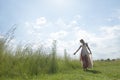 Dreamy portrait of bohemian blonde girl in field of grass Royalty Free Stock Photo