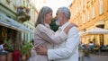 Dreamy senior Caucasian adult mature gray-haired couple woman man looking camera smiling hugging bonding cuddle thinking Royalty Free Stock Photo