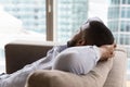 Dreamy sleepy young Black man relaxing on couch Royalty Free Stock Photo