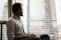 Dreamy smart young african american freelancer working on computer. Royalty Free Stock Photo