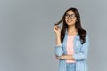 Dreamy smiling indian girl student wear shirt glasses looking at copy space Royalty Free Stock Photo