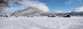 Dreamy snowy valley bottom with cabins in winter