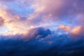 Dreamy sunset sky with vivid pink and orange fluffy clouds and sun rays running through air, storm, background. Royalty Free Stock Photo