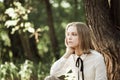 Dreamy teen girl in white blouse with black ribbon