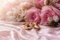 Dreamy wedding scene featuring gold rings, Eustoma roses, and light pink feathers. Royalty Free Stock Photo