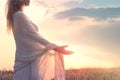 Dreamy woman holding the sun in her hands Royalty Free Stock Photo