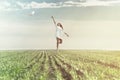 Dreamy woman runs happy in the middle of nature