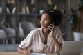Dreamy young african american woman holding telephone call. Royalty Free Stock Photo