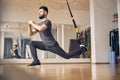 Dreamy young athlete performing a TRX lunge Royalty Free Stock Photo