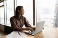 Dreamy female employee work on laptop planning Royalty Free Stock Photo