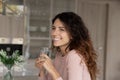 Dreamy young woman holding glass of fresh pure water.