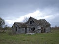 Dreary Abandoned Dilapidated Farm House with cloudy skies Royalty Free Stock Photo