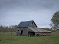 Dreary Abandoned Dilapidated Farm Shed with cloudy skies