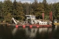 Dredger boat anchored by the lake shore Royalty Free Stock Photo